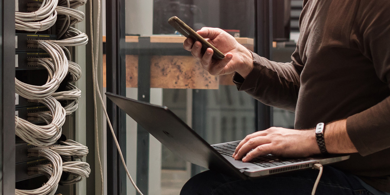ban checking phone whilst on his laptop