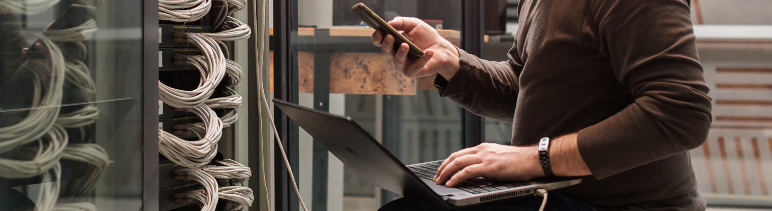 ban checking phone whilst on his laptop