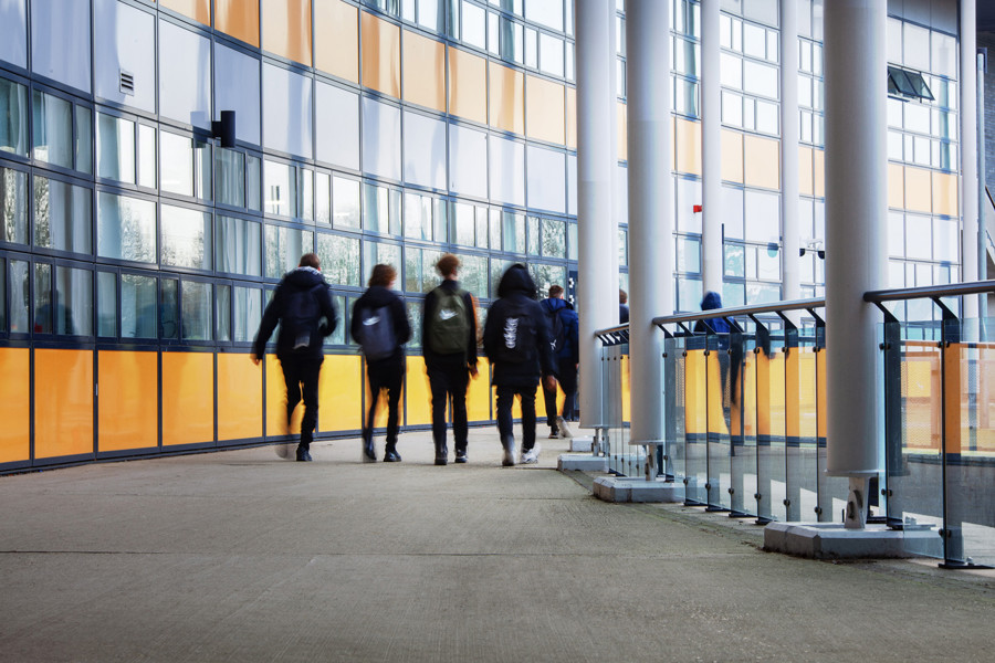 school children walking through a hall